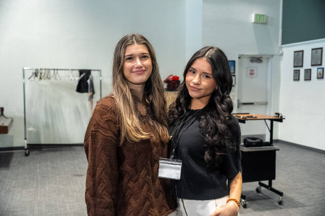 Two American Heritage delegates smiling together at the conference